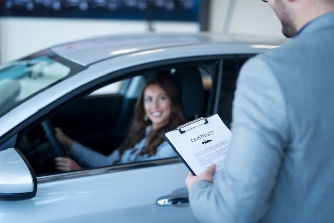 Customer receiving verified vehicle documents from a car dealer